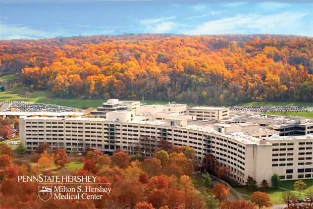 Penn State Hershey Medical Center building with fall foliage all around. The photo was taken from the sky.