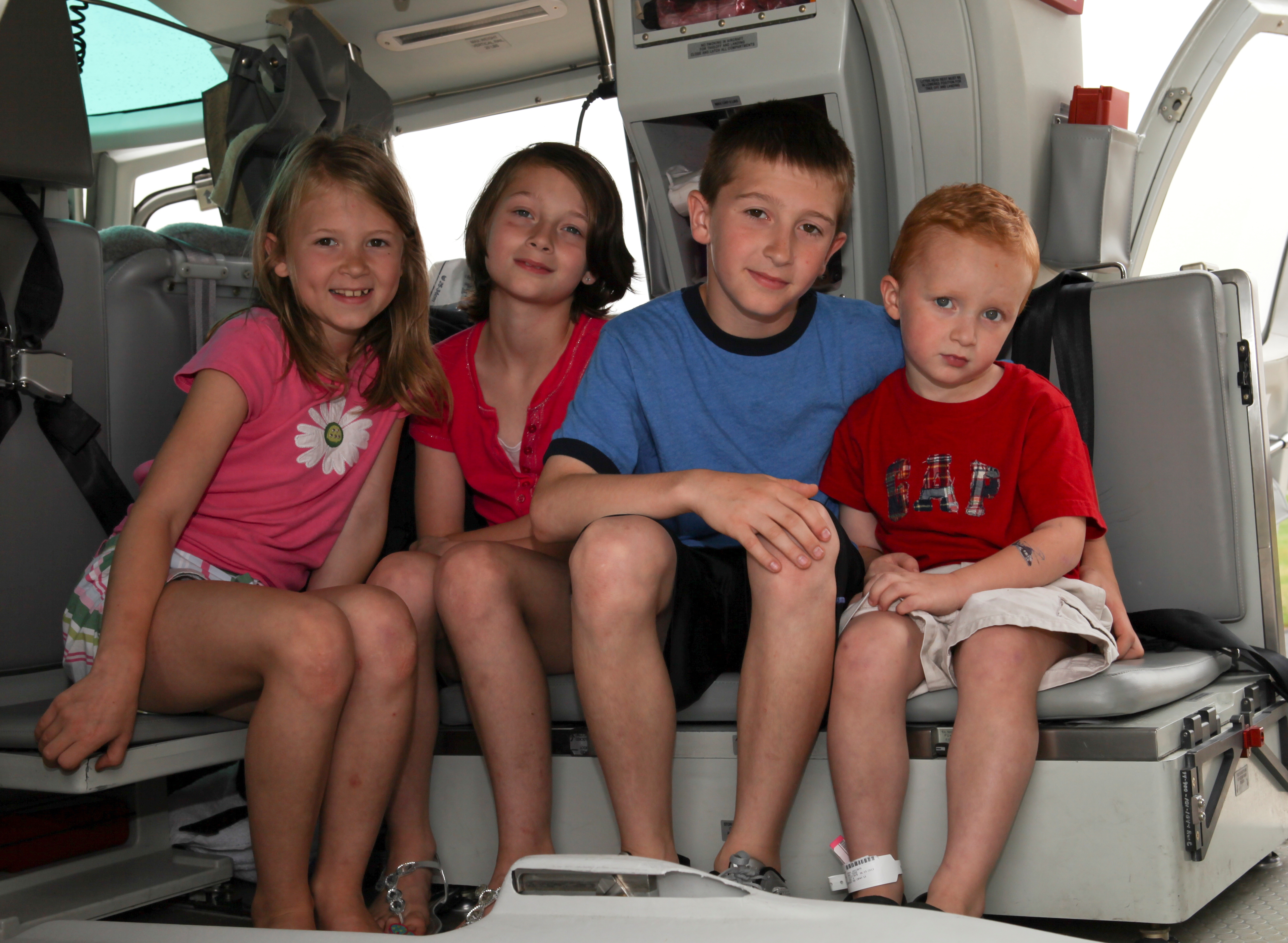 Caeley, Carrie, Jared and Jackson Bair get an inside look at a Life Lion aircraft.