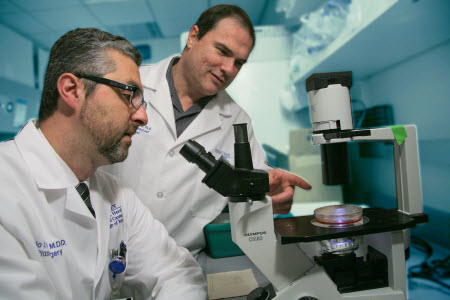 A photograph of Drs. Rogerio Neves and Gavin Robertson, who launched company Melanovus, in a research lab.