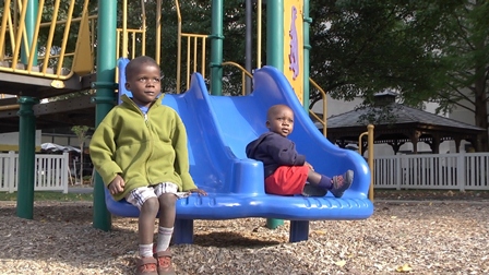 Edwin Mugerwa, age 4, and Nuashad Muwaya, age 1 on a playground at Penn State Hershey Medical Center after heart surgery.
