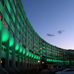 The entrance to the hospital with the LED lights shining green.