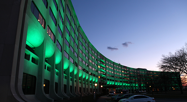 The entrance to the hospital with the LED lights shining green.