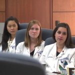 Four students from Penn State College of Medicine's University Park Regional Campus are seen seated at a conference table.