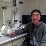 Han Chen, MD, PhD, became director of the Penn State College of Medicine Transmission Electron Microscopy Facility in February 2016. Chen is pictured at right, seated and facing the camera, with the microscopy equipment behind him to his left.