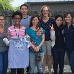 Members of the lab of Dr. Nadine Hempel are pictured in Summer 2016. The photo includes a group of eight people standing outdoors. Dr. Nadine Hempel, the laboratory PI, is fourth from right. Lab members in the front are holding a Penn State College of Medicine shirt and sticker.
