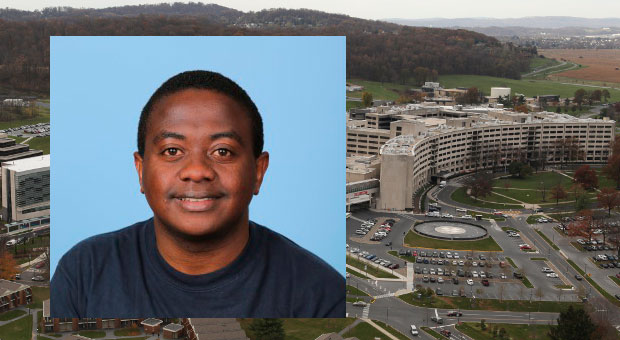 An abstract by MPH student Paddy Ssentongo was chosen for presentation at the Johns Hopkins University Public Health in Asia Symposium in February 2016. A photo of Ssentongo in a navy blue T-shirt, against a blue background, is superimposed on top of a photo showing an aerial view of the Penn State College of Medicine campus to the right.