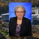 Barbara Ostrov, MD, was named associate dean for faculty and professional development at Penn State College of Medicine in September 2016. Ostrov is pictured wearing a purple patterned blouse, dark blazer and glasses, in front of a blue photo background. Her photo is superimposed on the left side of an aerial image of Penn State College of Medicine's Hershey campus, with the College Crescent visible at right.