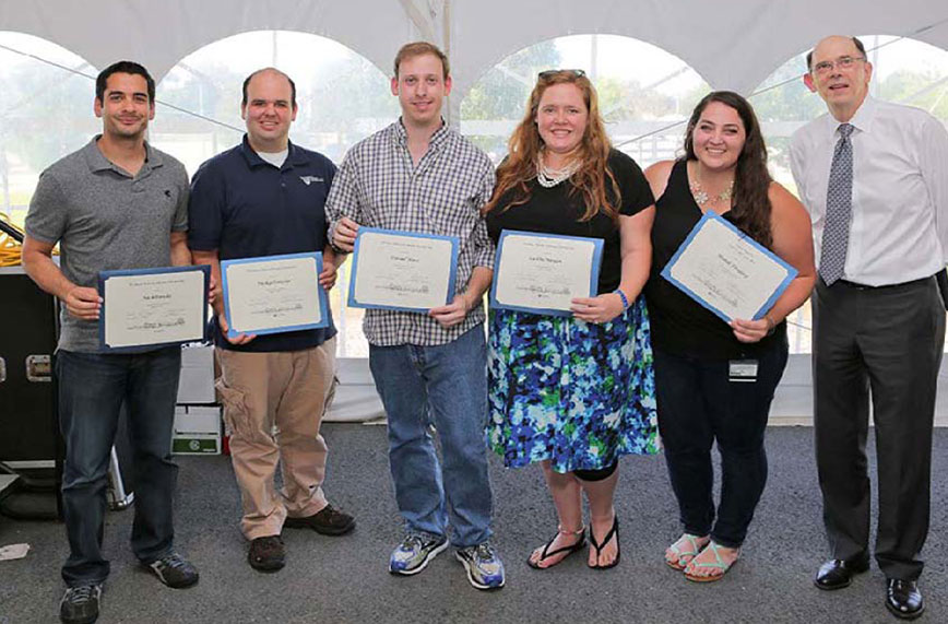 Several Penn State College of Medicine graduate students were honored Aug. 19, 2016, with the Graduate Alumni Endowed Scholarship and the Class of 1971 and 1974 Awards. Pictured are award recipients Nick Parekh, Phillip Domeier, Dan Hass, Caitlin Nealon and Mandi Feinberg with Charles Lang, PhD, Interim Associate Dean for Graduate Studies and Distinguished Professor. The students are pictured in an outdoor event tent with Dr. Lang at right. All students are holding certificates and smiling.