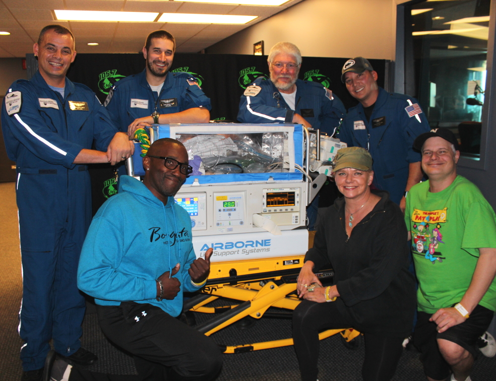 Earl David Reed, Jen Shade and Nipsey pose with members of Penn State Life Lion Critical Care Transport.