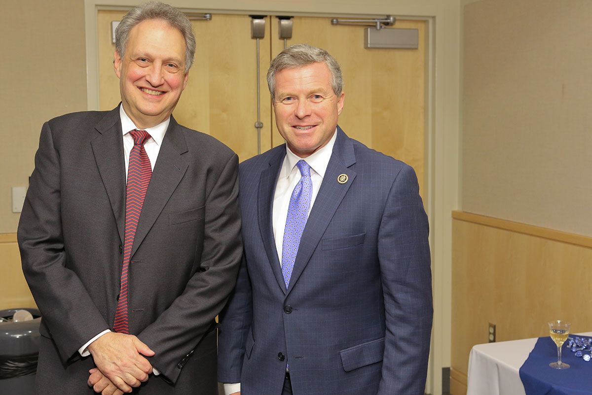 Lawrence Sinoway, MD, left, director of the Penn State Clinical and Translational Science Institute, and Charlie Dent, U.S. Representative for Pennsylvania's 15th District, are seen at the celebration honoring the renewal of the NIH Clinical and Translational Science Award grant. Sinoway is wearing a dark suit, white dress shirt and red patterned tie, and Dent is wearing a blue suit, white dress shirt and light blue patterned tie.