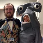Ian Hayman, left, and Taryn Mockus, both graduate students at Penn State College of Medicine, took part in the 2016 Penn State Health Children's Hospital Halloween Trick-or-Treat Parade. Hayman is pictured at left wearing a costume that includes a vest, cape and bowtie, and Mockus is pictured at right in a gray shark costume.
