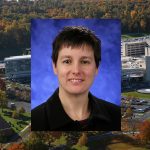 Sarah K. Bronson, PhD, was named Associate Dean for Interdisciplinary Research at Penn State College of Medicine in November 2016. She is pictured wearing a black dress shirt, in front of a dark blue photo background. Her picture is overlaid on an aerial view of Penn State College of Medicine's campus.