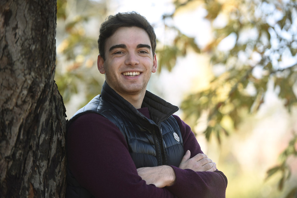 Penn State MD/PhD candidate and Schreyer Honors Scholar Alexandre Bourcier's work won an award at a November conference. Bourcier is pictured outdoors wearing a maroon shirt and dark vest.
