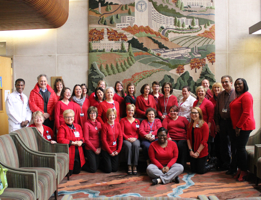 Faculty and staff from Penn State Heart and Vascular Institute pose for a photo. All are wearing red.