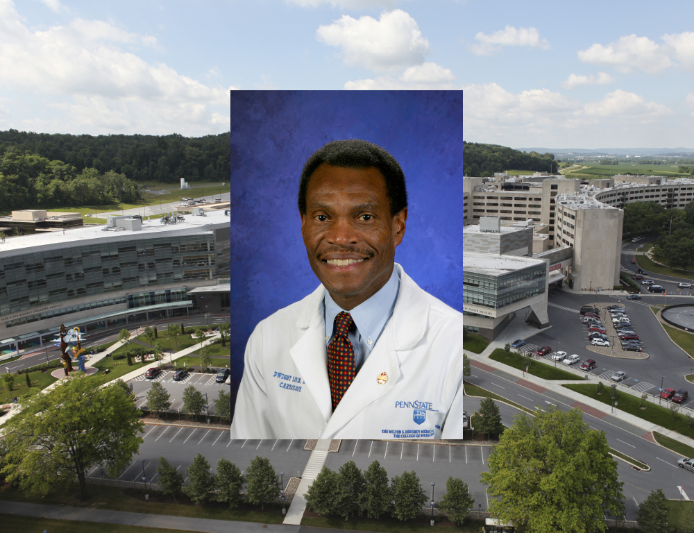 An aerial view of the Penn State Hershey campus is in the background. Placed over top in the center is a photo of Dr. Dwight Davis, who's wearing a tie and white physician's coat and posing in front of a blue backdrop.