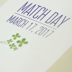 Match Day, in which fourth-year medical students learn their residency destinations, was held March 17, 2017. A program from the event is seen on a white tablecloth, with Match Day March 17, 2017 and the Penn State College of Medicine logo visible on the cover. Four shamrocks also appear, in honor of Match Day coinciding with St. Patrick's Day.