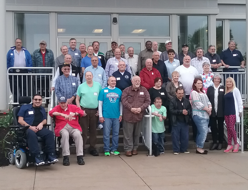 Approximately 40 people - all heart transplant recipients - pose for a photo on the steps of the University Conference Center on the Hershey Medical Center campus.