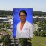 Annyella Douglas poses in a white coat against a blue backdrop; the image is superimposed over an aerial view of the Milton S. Hershey Medical Center-Penn State College of Medicine campus.