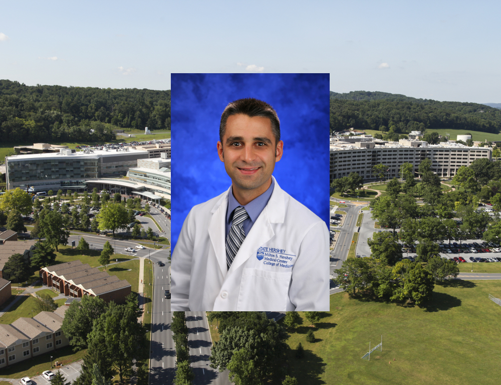 A stock photo of Dr. Jed Gonzalo wearing a white coat in front of a blue backdrop; superimposed over an aerial shot of the Milton S. Hershey Medical Center-Penn State College of Medicine campus.