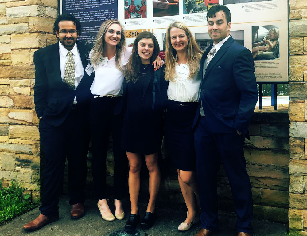 From left, Nirmal Ahuja, Mallory Hidinger, Madison Taylor, Alyssa Brandt and Bryan Caffrey represented Penn State in a public health competition in Atlanta. The five people are pictured wearing semi-formal/business attire stand outside in front of a sign with a stone base.
