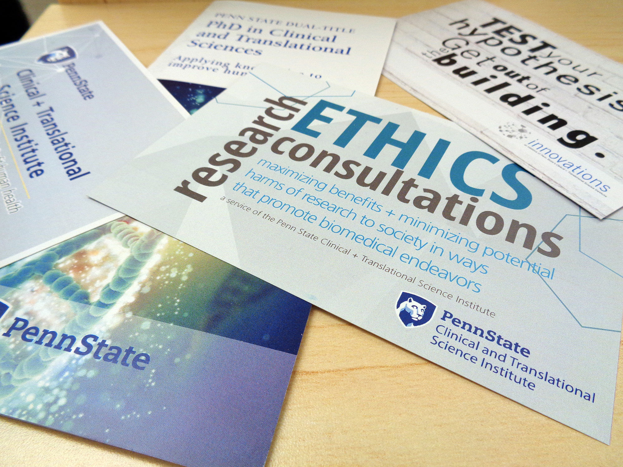 A promotional image for Penn State Clinical and Translational Science Institute shows a number of pamplets and cards advertising CTSI services fanned out on a table. The words 