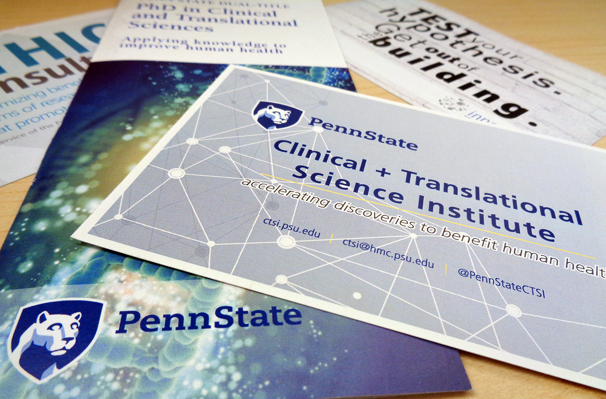 A promotional image for Penn State Clinical and Translational Science Institute shows a number of pamplets and cards advertising CTSI services fanned out on a table.