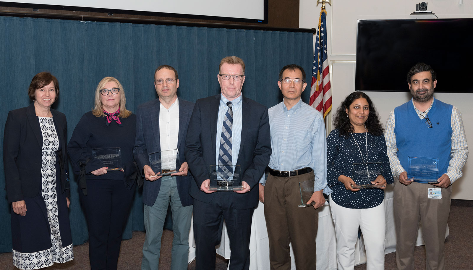 The 2018 Outstanding Collaborative Research Award was presented to a team from Penn State Tobacco Center of Regulatory Science. A group of six people are pictured holding awards, with Dr. Leslie Parent, Vice Dean for Research and Graduate Studies at Penn State College of Medicine, standing at left.