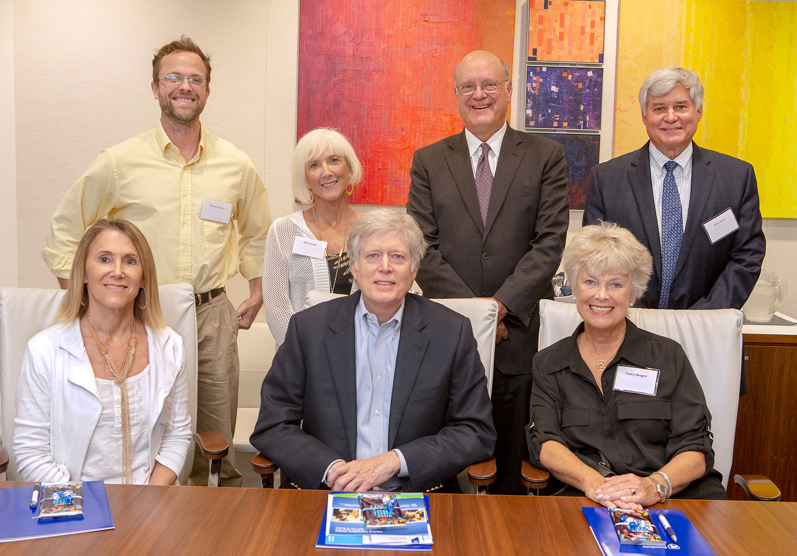 Dr. A. Craig Hillemeier, dean, Penn State College of Medicine, chief executive officer, Penn State Health, and senior vice president for health affairs, Penn State (second from right in back row) meets with trustees of the Kunkel Foundation to discuss the scholarship agreement. The group of seven people are pictured in two rows, with the front row sitting at a table and the back row standing behind them.