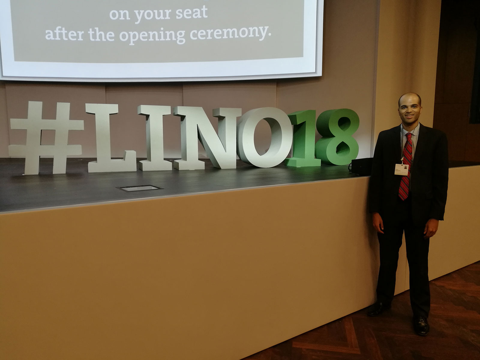 Penn State College of Medicine Biomedical Sciences PhD student Robert Nwokonko traveled to Lindau, Germany, for the 68th Lindau Nobel Laureate Meeting, held June 24 to 29, 2018. Nwokonko is pictured standing in a large space with three-dimensional letters spelling out #LINO18 standing next to him on a wall or ledge.