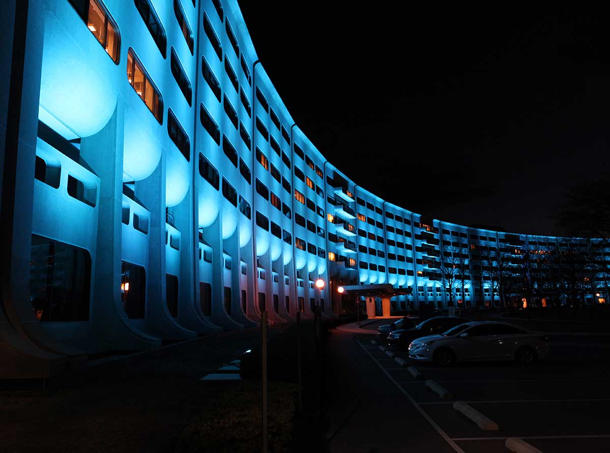 Exterior building lit with blue lighting.