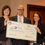 Dr. John Elfar, center, receives a check from Clare Thibodeaux, director of scientific affairs, Cures Within Reach, and Barbara Goodman, president and COO, Cures Within Reach.