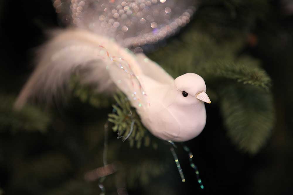Dove ornaments on a pre lit Christmas tree.