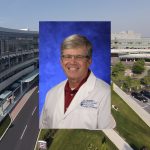 A head and shoulders photo of Dr. Kent Hymel in a physician's coat, superimposed over a photo of Hershey Medical Center.