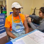 Penn State College of Medicine student Himadri Patel gives Clay Lambert a flu shot at the LionCare clinic.