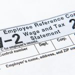 The top of the W-2 tax form photo is shown at angle.
