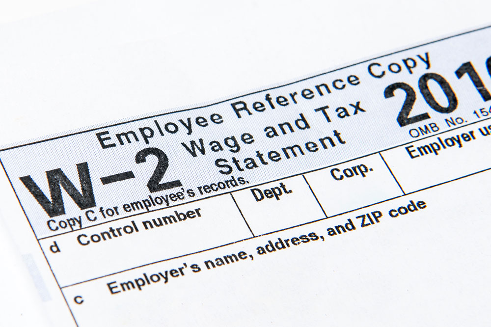 The top of the W-2 tax form photo is shown at angle.