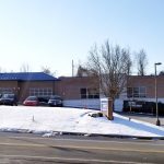 A two story medical building is shown on a snowy road.