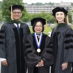 Dr. Peter Zaki, Dr. Shou Ling Leong and Dr. Sarah Stovar stand in a row in commencement caps and gowns.