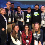Members of Penn State College of Medicine's physician assistant program National Challenge Bowl team and program alumni and leadership are seen kneeling and standing in a group.