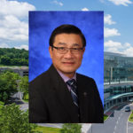 A head-and-shoulders professional photo of Duanping Liao is seen superimposed on an aerial photo of the campus of Penn State Health Milton S. Hershey Medical Center and Penn State College of Medicine in Hershey.