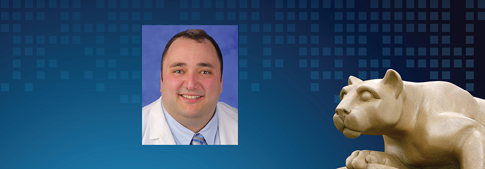 Dr. Karl Clebak is pictured on a blue background with a statute of the Penn State Nittany Lion.