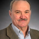 A head-and-shoulders professional photo of Dr. James Adair