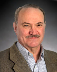 A head-and-shoulders professional photo of Dr. James Adair