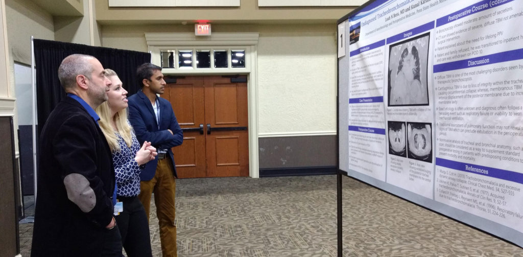 Faculty and trainees look at a poster at Penn State College of Medicine's 2019 Resident and Fellow Research Day.