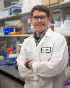 A professional photo of Scott Walker of Merck standing in a lab.