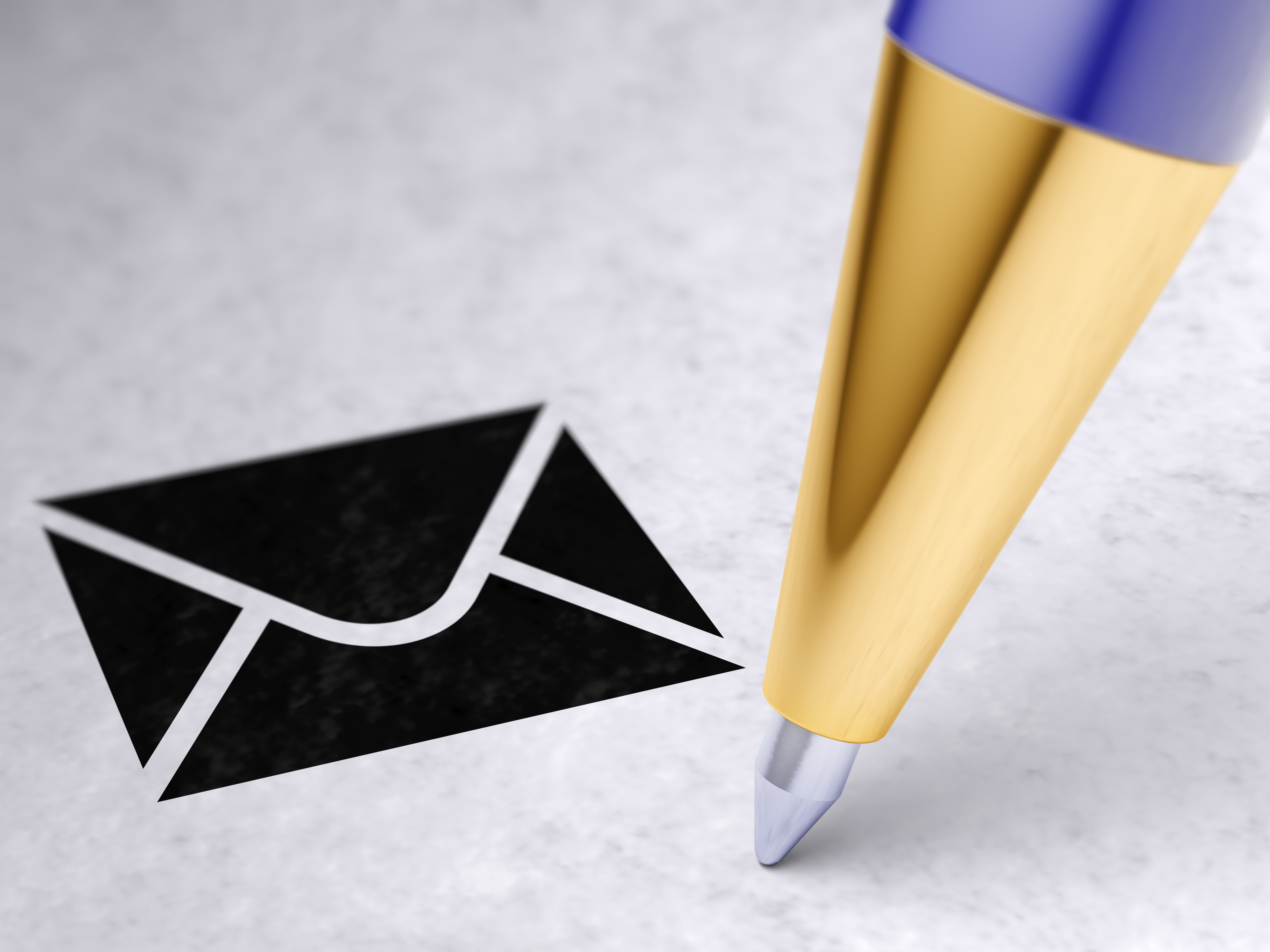 A close up of a pen point is shown near an image of an email icon.