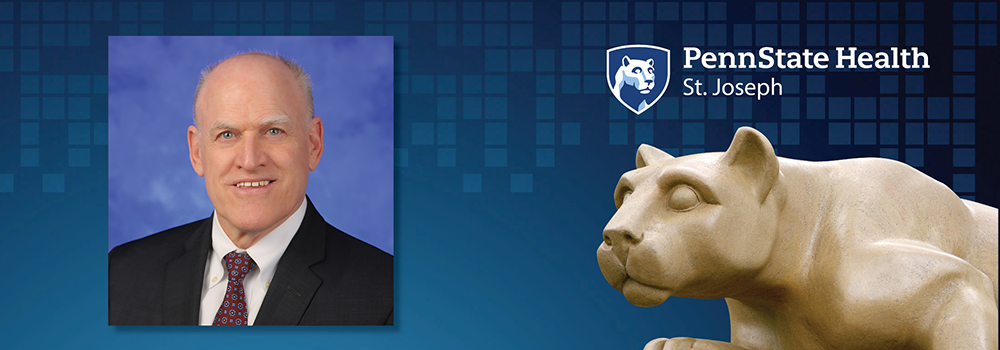 An image of John Morahan is shown next to a statue of the Penn State Nittany Lion.