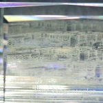 A close-up image shows Penn State College of Medicine's glass Research Recognition Awards lined up on a table.