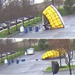 Four different images show a large tent being knocked down by high winds. Barrels and trees are in the foreground.