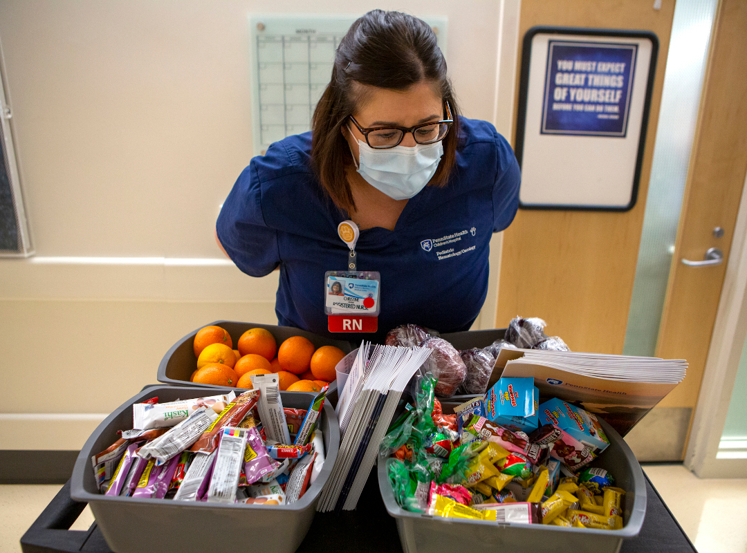 A woman looks over a table of donations